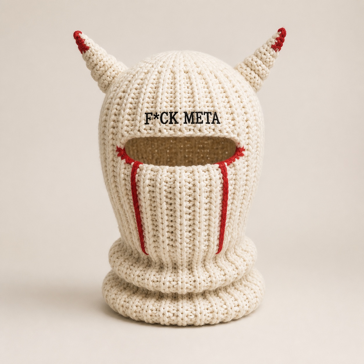Ivory chunky-knit balaclava with red-edged horns.